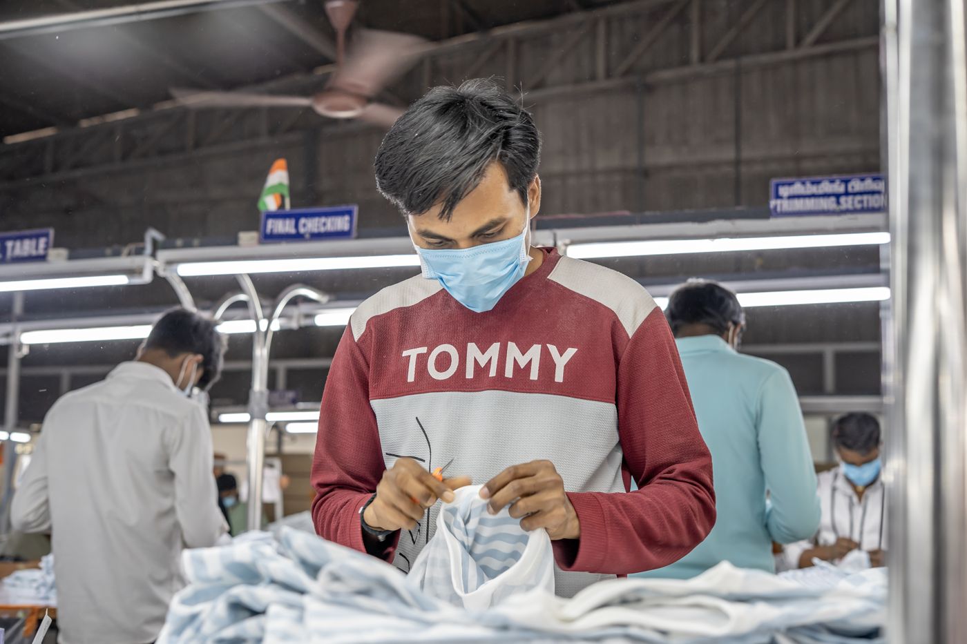 Quality checker inspecting garments
